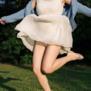 Visualprompt.org snapshot of a model in a chiffon one piece dress at a park c9c256fa9e